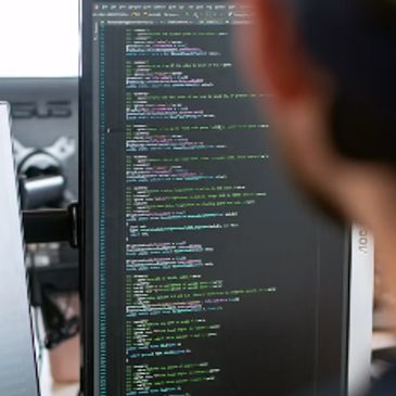 Person viewing code on a computer monitor.