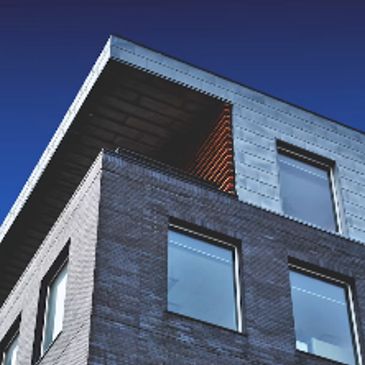 Modern building corner with large windows.