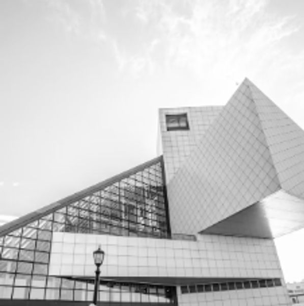 Modern geometric building with glass and tiled exterior.