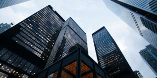 Looking up at tall skyscrapers in a city.