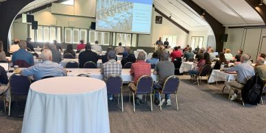 Audience attending a presentation in a conference room.