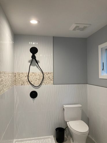 Modern bathroom with shower and toilet.