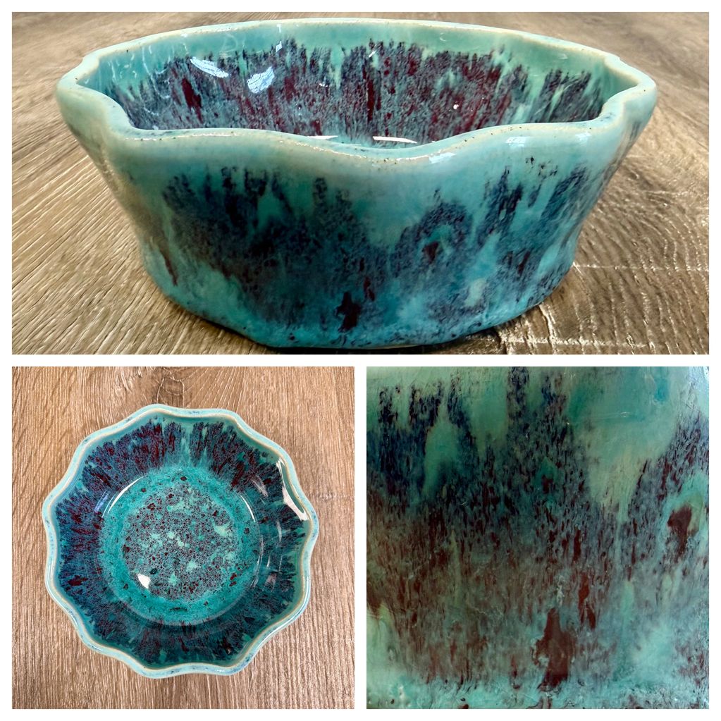 Turquoise ceramic bowl with a wavy rim and dark speckled glaze.