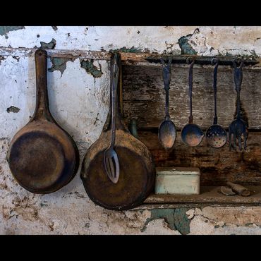 worn cast iron pans and utensils at Shakespeare Ghost Town, New Mexico.