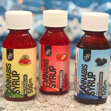 Three bottles of cannabis syrup in watermelon, strawberry, and blue raspberry flavors.
