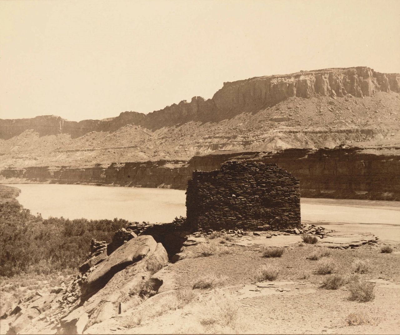 View of ruins of a prehistoric fort and the Vermilion Cliffs of Arizona, taken during the Brown-Stanton survey of the Colorado River's canyons in 1889. Photographer Frederick Monsen noted, There are many remarkable ruins in this vicinity but the country is very difficult to travel over.