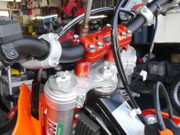 Close-up of a motorcycle handlebar and front suspension.