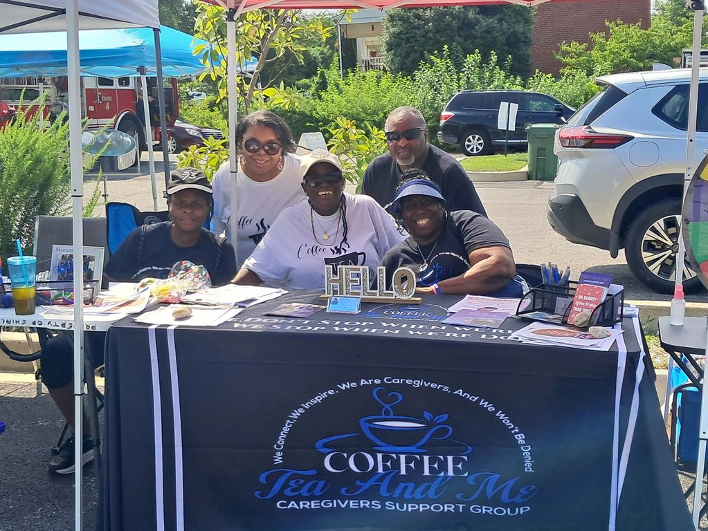 Five people at a Coffee Tea And Me caregiver support group booth.