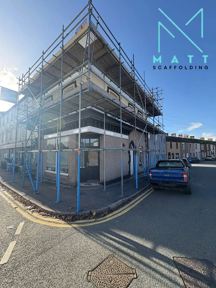 Building surrounded by scaffolding on a sunny day.