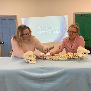 Tracy and Jo looking at and discussing a spine