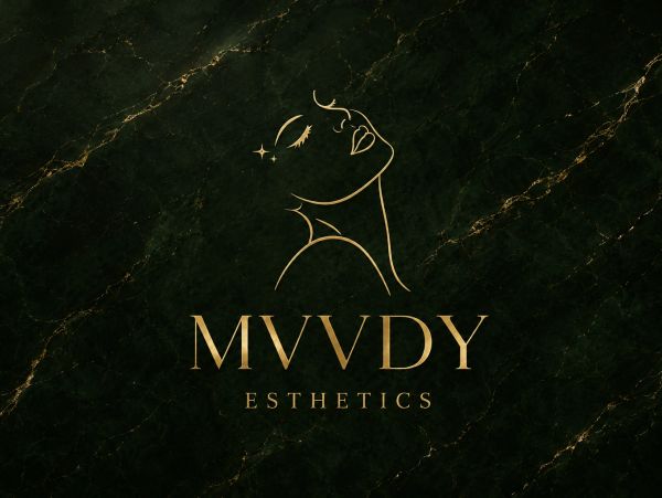 Elegant gold line art logo for MVVDY Esthetics on dark marble.