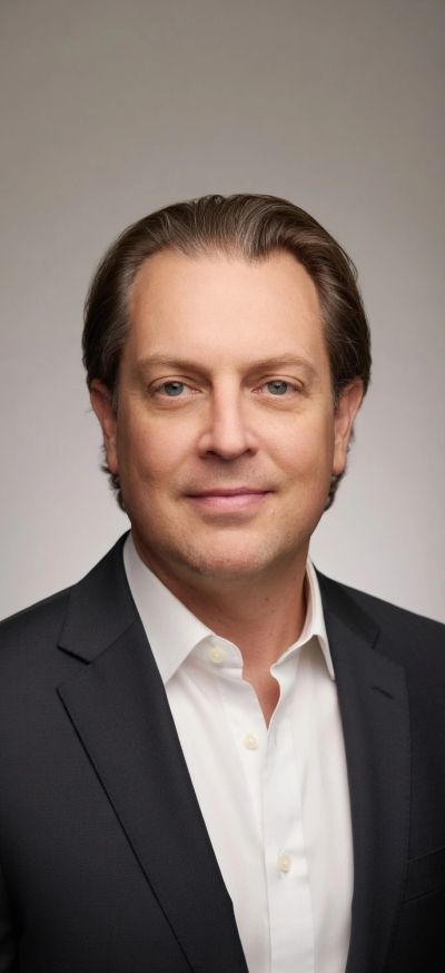 Professional headshot of a man in a suit.