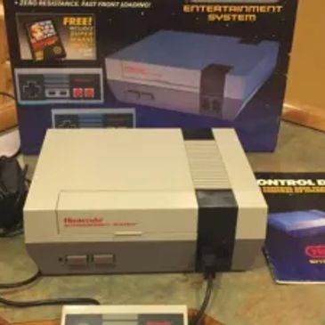 Classic Nintendo Entertainment System console with controller and box.