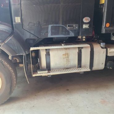 Side view of a truck's fuel tank and step area.