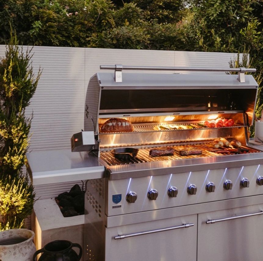 Premium freestanding grill with meat and bbq cooking on it