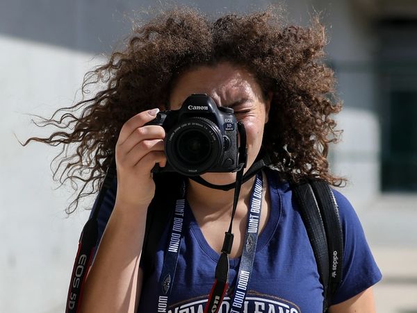 Person taking a photo with a Canon camera.