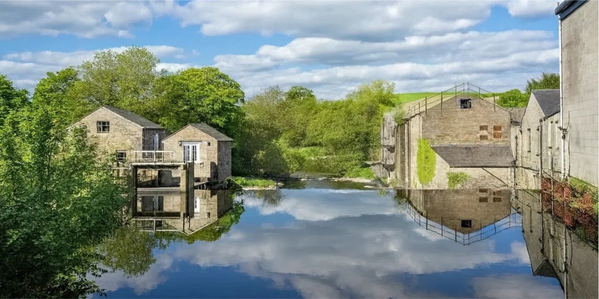 Oakenclough Mill and its millpond on a sunny day