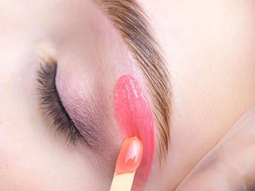 Eyebrow waxing with hard wax for precise brow cleanup and smooth, defined results