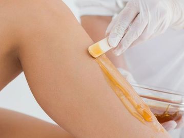 Half leg waxing treatment applying warm wax for smooth lower legs