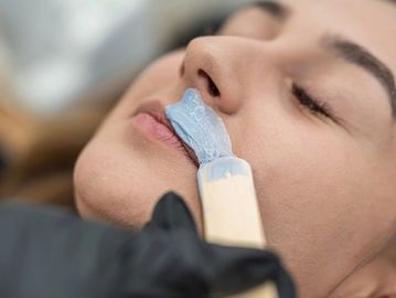 Professional lip waxing service for facial hair removal and smooth upper lip