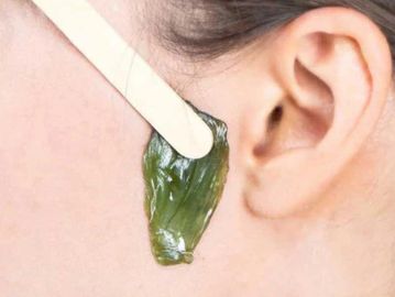 Sideburn waxing with strip wax for clean and defined facial hair removal