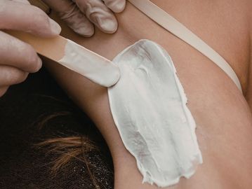 Underarm waxing treatment with creamy wax for smooth and long-lasting hair removal