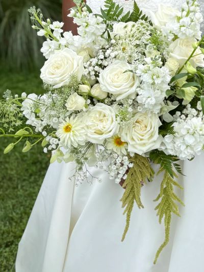 Elegant bridal bouquet with white roses and delicate greenery.