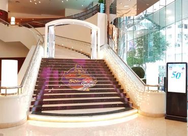 Elegant indoor staircase with decorative lighting and a colorful design on the steps.