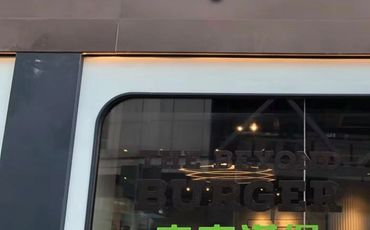 Shop window with 'BEYOND BURGER' signage and interior lights.
