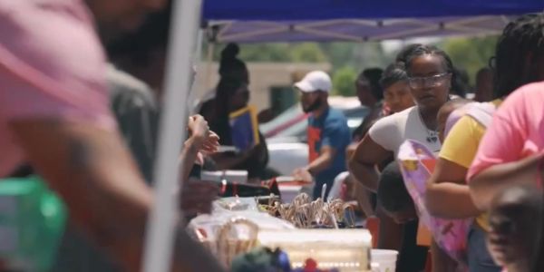 People shopping at an outdoor market or fair.
