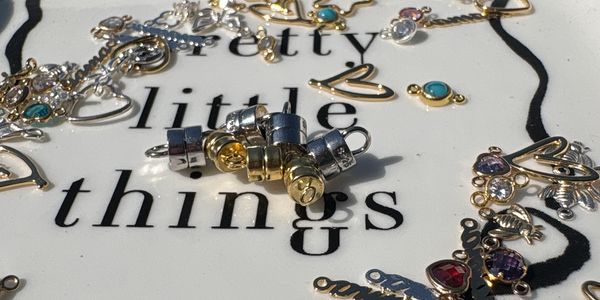 Assorted jewelry pieces on a white surface with text.