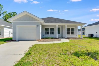 Modern single-story house with a front porch and garage.