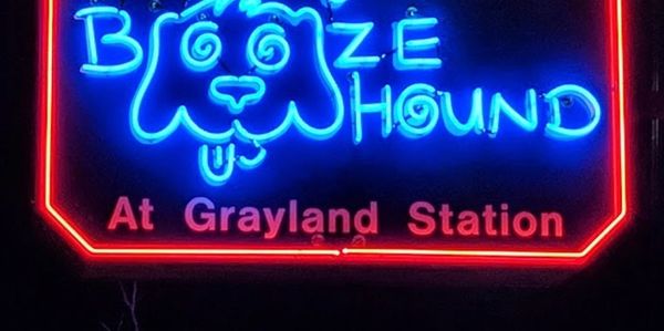 Neon sign for The Brooze Hound at Grayland Station.