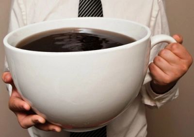 Person holding an oversized coffee cup.