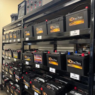 Shelves stocked with Deka automotive batteries in a store.