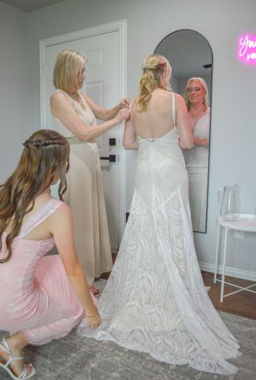 Bride getting ready with help from bridesmaids.