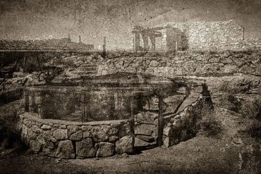 Ancient stone structures in a barren landscape.