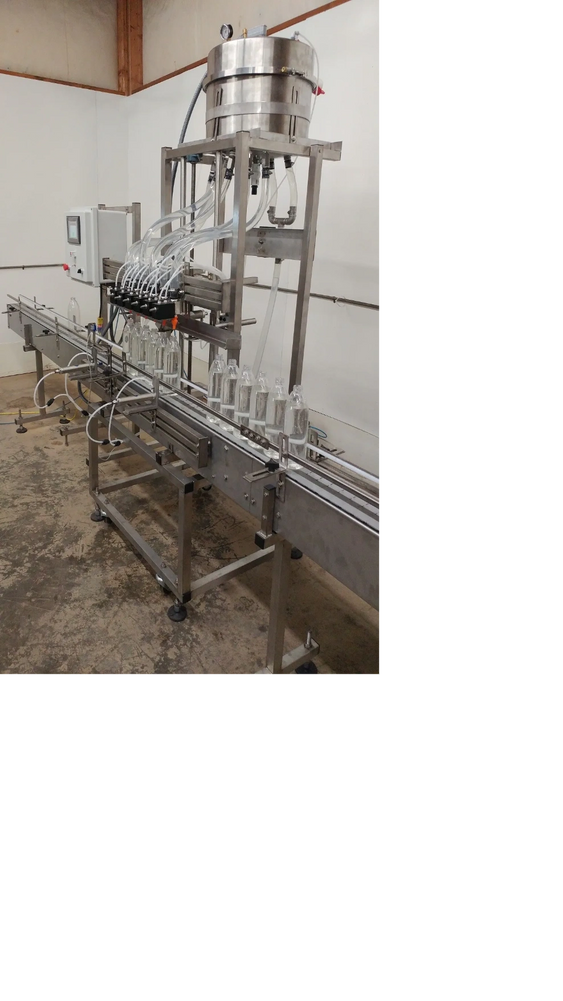 This very accurate automatic volumetric gravity filling machine is being tested with water using cle