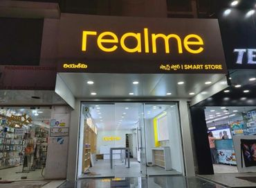 Realme smart store entrance with bright signage and glass doors.