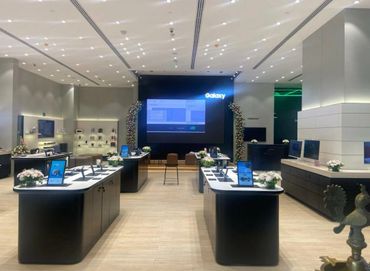 Modern Galaxy store interior with sleek displays and floral decor.