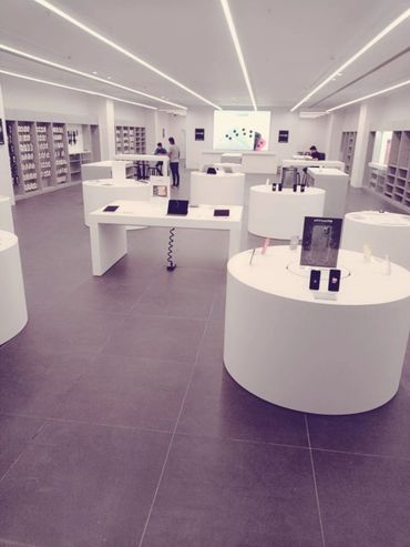 Modern tech store with sleek white displays and gadgets.
