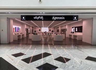 Modern Aptronix store showcasing Apple products in a sleek, spacious setting.