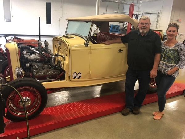 Classic Car Collector with his daughter documenting a memory with this 1932 Ford Roadster