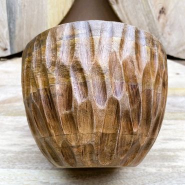 Hand-carved wooden bowl with textured pattern.