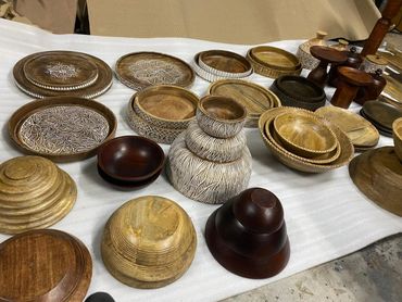 Collection of various handcrafted wooden bowls and containers on display.