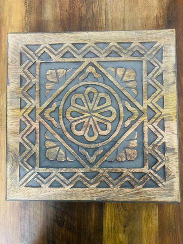 Intricately carved wooden panel with geometric and floral patterns.