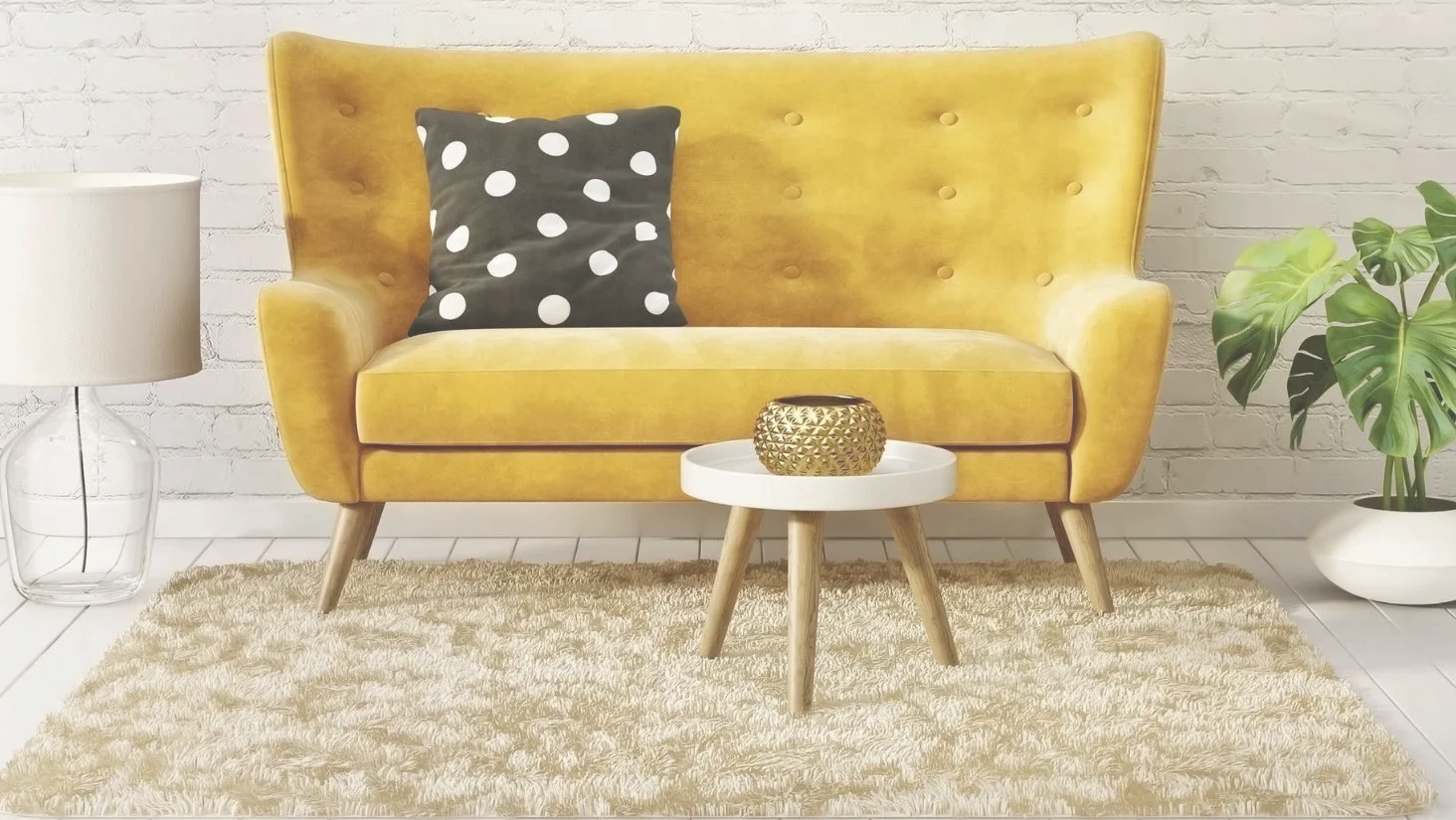 Bright yellow couch with polka dot pillow in a cozy living room setup.