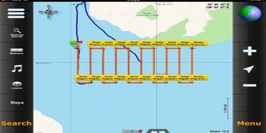 Digital marine navigation map showing plotted routes and waypoints over a coastal area.