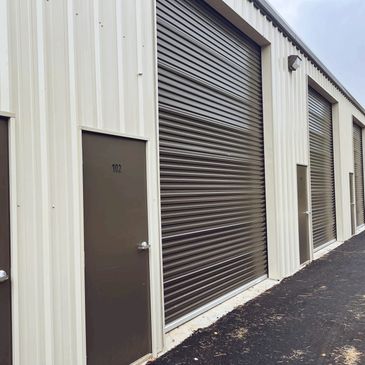 Photo of walk-through door and large overhead garage door