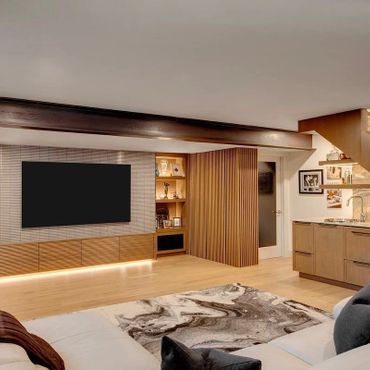 Modern living room with wooden accents and a large TV on the wall.